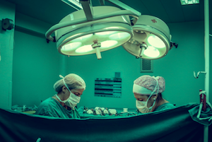 Two surgeons operate on a person Surgery with surgical staplers