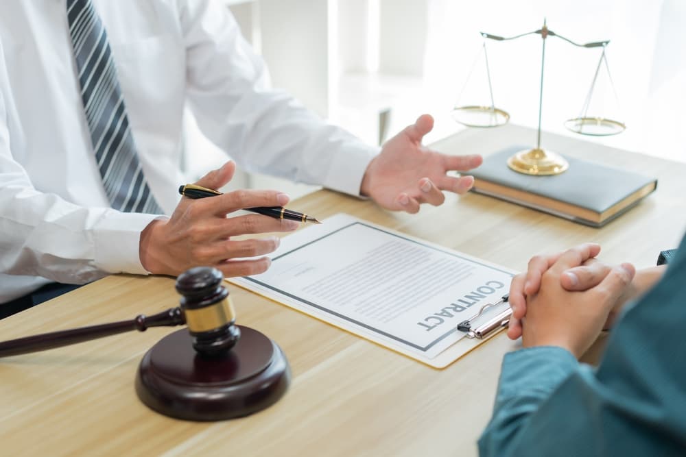 Law consultancy concept: A male lawyer reviewing unclear information in a contract and requesting further explanation.