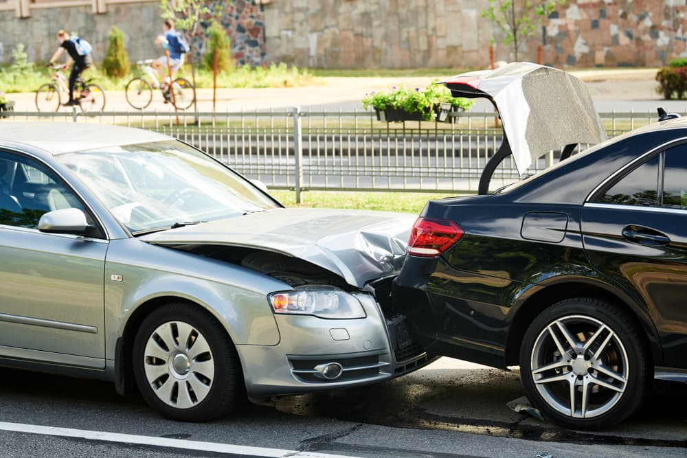 Damaged automobiles at the scene of a street car accident.