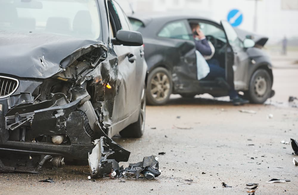 Car crash on a city street, with damaged vehicles following a collision.
