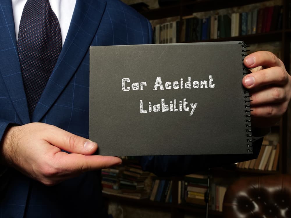 Conceptual image illustrating Car Accident Liability, featuring the phrase handwritten on paper.