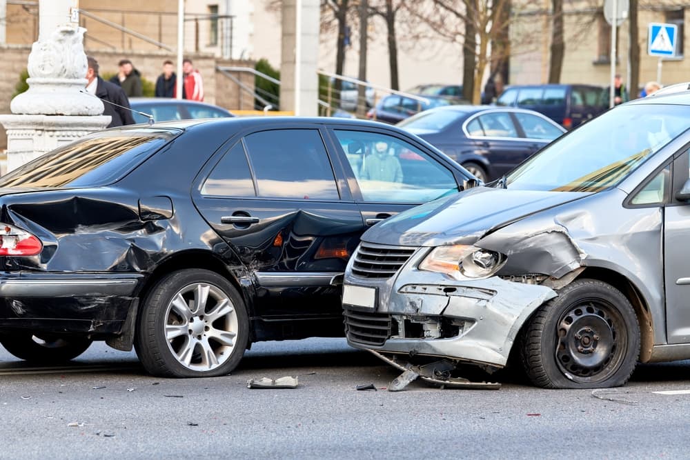 Car crash accident on the street involving damaged automobiles.
