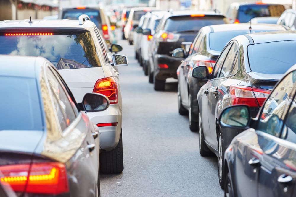Heavy traffic jams on a highway during the holiday season, showing cars leaving the city for a weekend getaway.