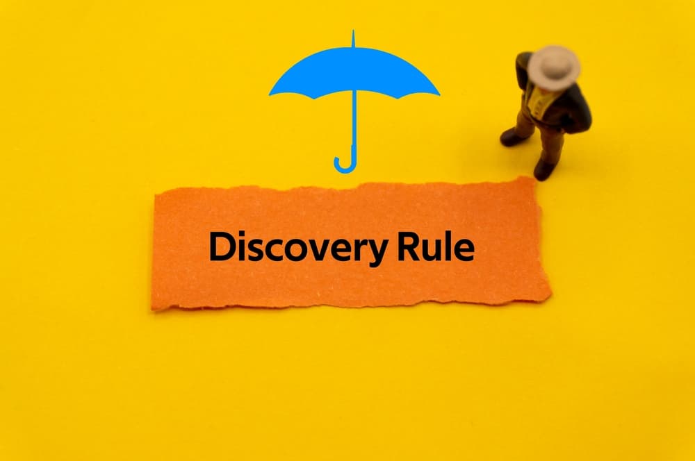 Discovery Rule – the term is written on a slip of colored paper, representing insurance, healthcare, and life insurance terminology.