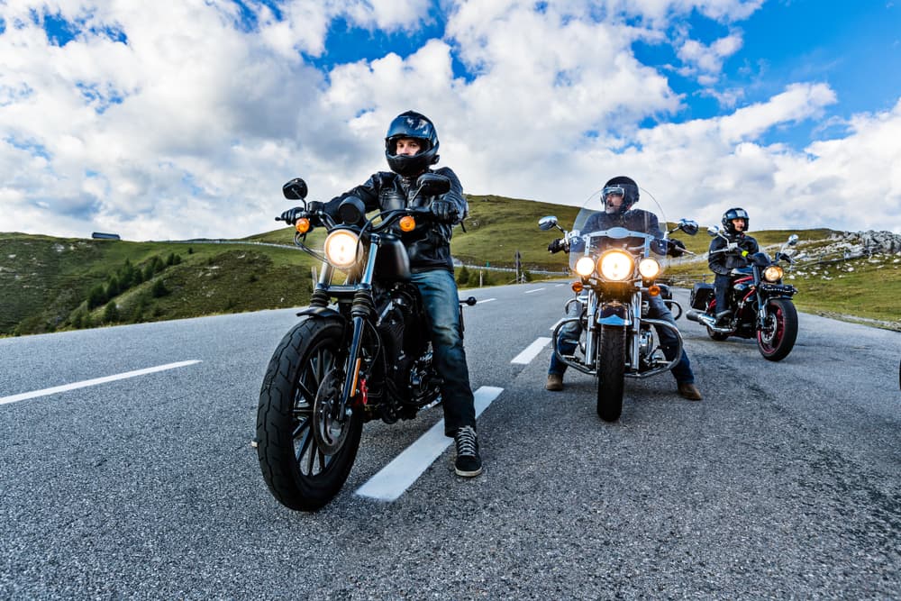 Motorcyclists cruise down the road, embodying motion, freedom, and the thrill of the ride.