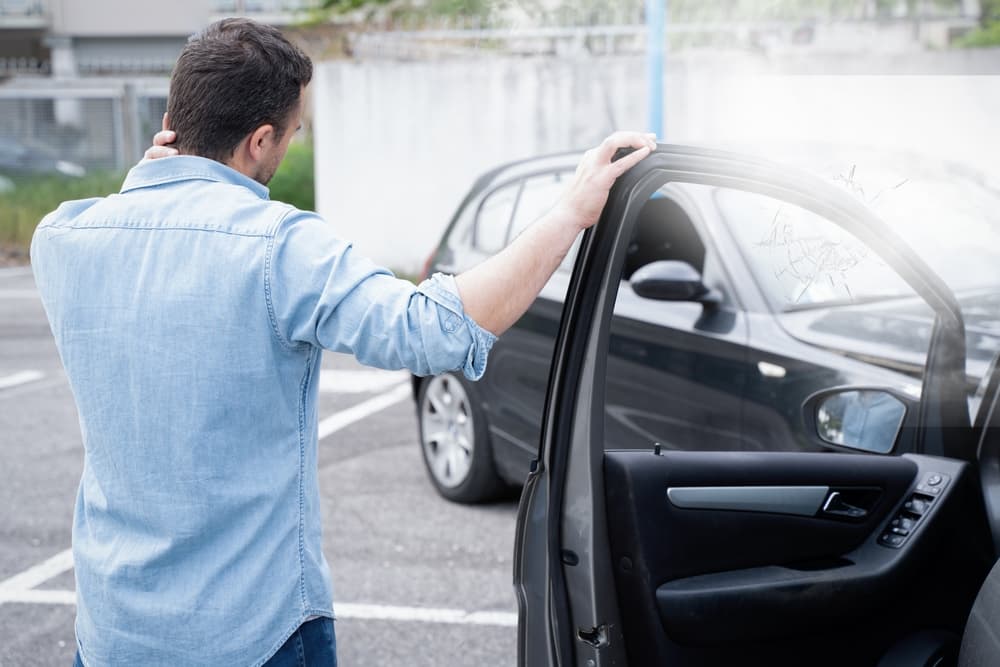 A man in pain after suffering an injury in a car crash.
