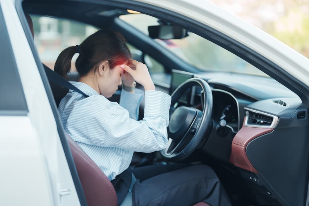 A woman experiences headache and pain and suffering following a car accident.