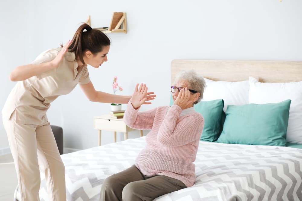 An image depicting caregiver mistreatment of a senior woman in a nursing home highlights issues of elder abuse, neglect, and the urgent need for proper care and protection for the elderly.