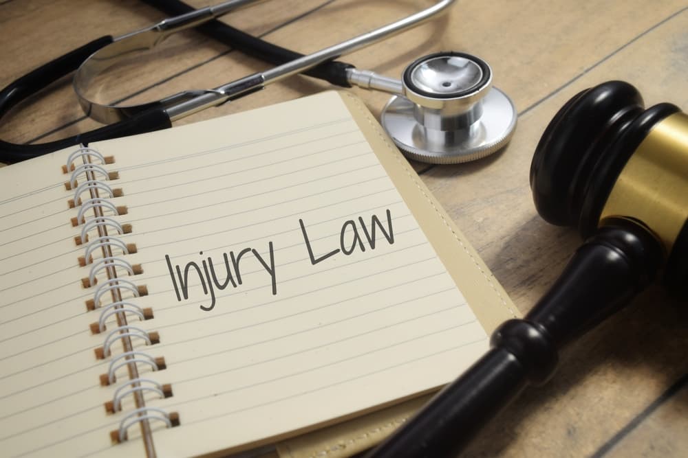 Injury Law text displayed alongside a gavel and stethoscope.