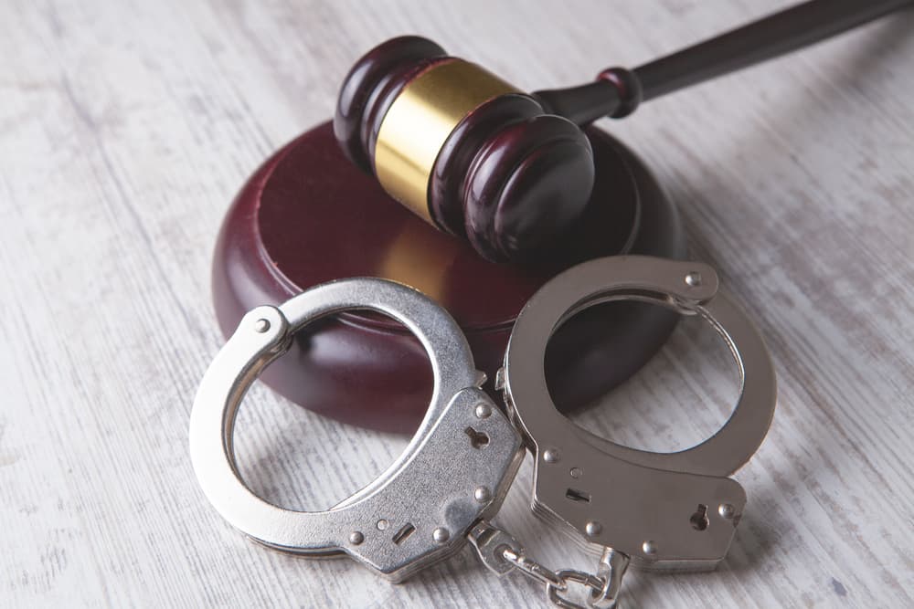 A legal concept image depicting a gavel and handcuffs.