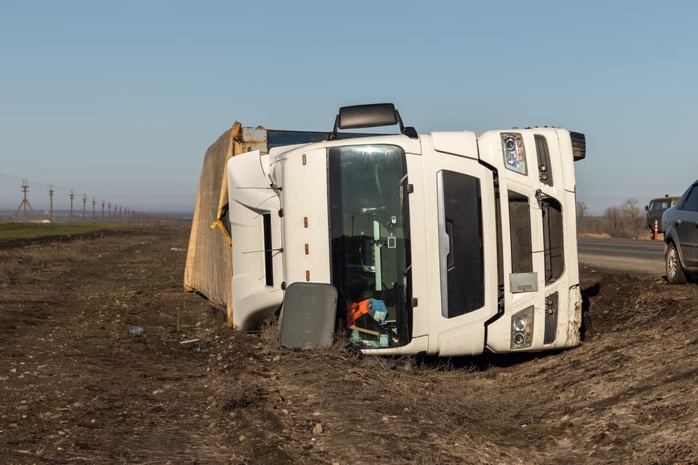 The large truck rests in a roadside ditch following the accident.