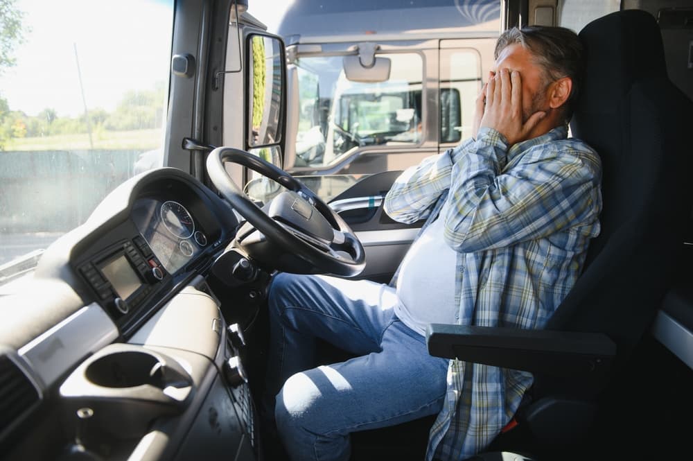 Portrait of an exhausted truck driver looking sleepy and unwell.

