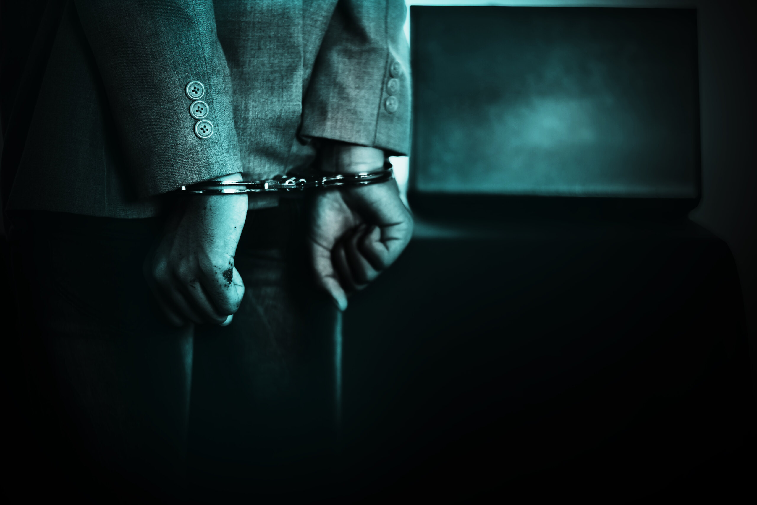 Handcuffed person in a dark setting symbolizing legal consequences and holding responsible parties accountable for sexual abuse in Florida.