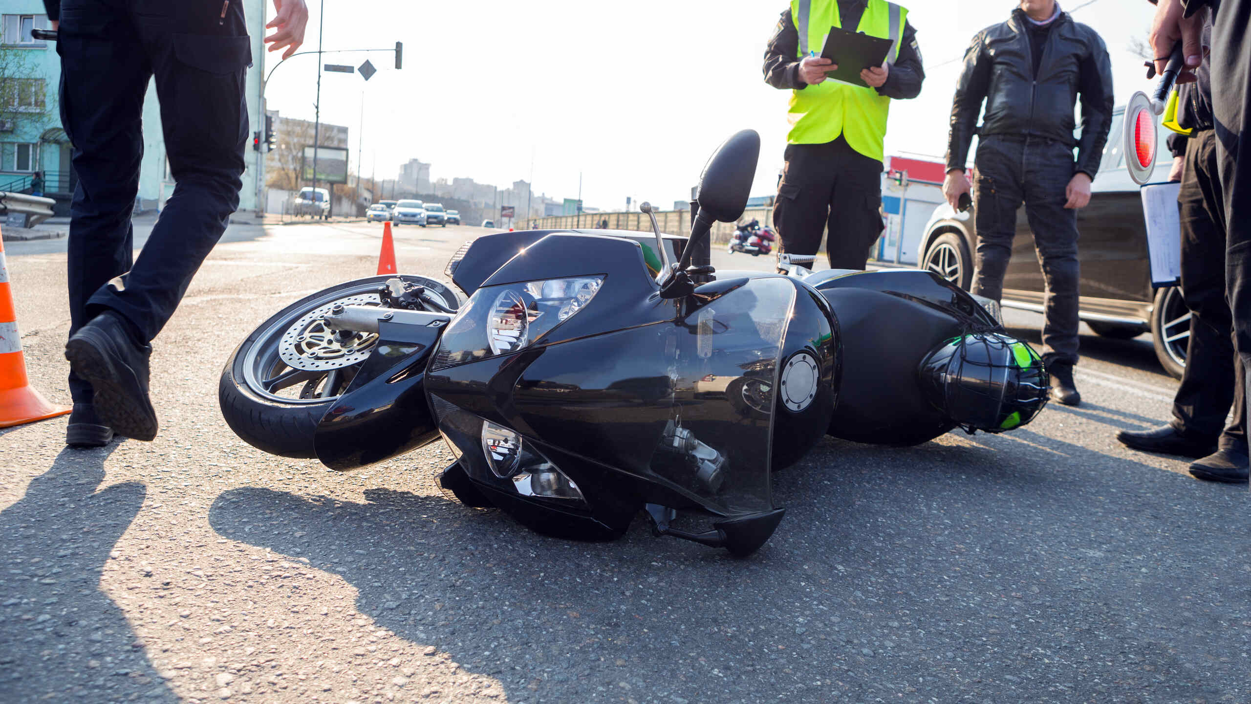 Police officers investigating a motorcycle accident on a Florida roadway, highlighting causes of motorcycle crashes