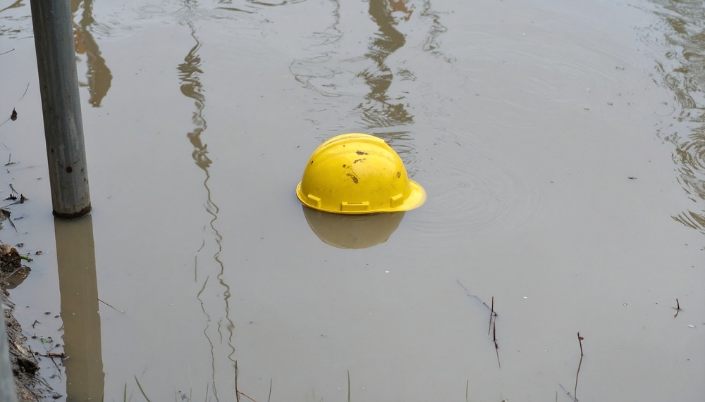 Hard hat floating in standing water at a Boca Raton construction site