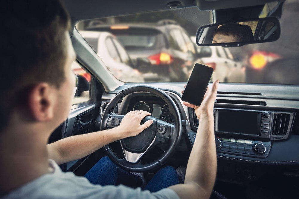 Driver using a phone while stuck in traffic