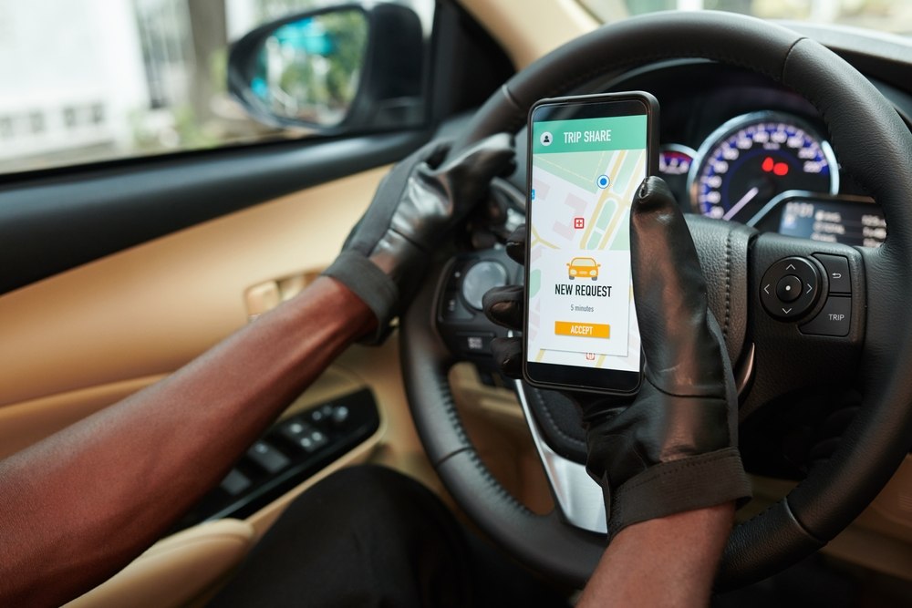 Rideshare driver accepting a trip request while driving